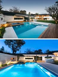 The Outdoor Space Features An Expansive Grassy Area With Swimming Pool An Outdoor Kitchen And Covered Enter Modern Pools Australian Homes Modern Pool And Spa