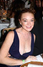 Lindsay Lohan suffers unfortunate nipple slip in plunging blue dress at a  party in Italy - Irish Mirror Online