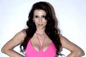 Pretty in pink, Claudia sizzles in front of the camera