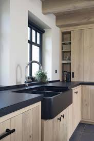 Black And Wood Kitchen Matte Black Countertops Window Pairs Lovely With The Textures Of Natural Wood Ind Rustic Kitchen Design Solid Wood Kitchen Cabinets Solid Wood Kitchens