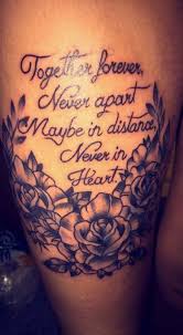 Literary style quote lettering in printed letters with cheshire cat's smile colored tattoo on thigh. Quote Tattoos For Women On Thigh