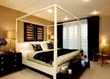 An all black tropical room with green accents, interesting pendant lights, rustic gold pots, and a huge dark gray cozy bed. 15 Refined Decorating Ideas In Glittering Black And Gold