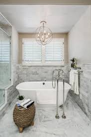 Chic Freestanding Tub Boasts Classic Tub Filler Small Bathroom Chandelier Minimalist Bathroom Design Tub Lighting