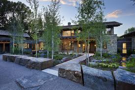 Luxury apartments, houses combining cachet and modernity, charming villa, mansion or traditional buildings. Contemporary Stone Farmhouse With Aged Wood Siding