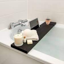 This simple expandable bathtub caddy comes in dark or natural wood finishes and has slots for books, candles, a loofah, soap, a. Black Bath Rack Wooden Tray The Bath Rack