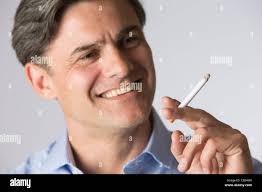 Smoking, man inhaling a cigarette, close up Stock Photo
