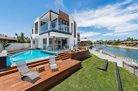 Contemporary home with pool has black and white interior. Modern Home Design In Broadbeach Waters With A Contrasting Interior Between White Natural Wood And Black Caandesign Architecture And Home Design Blog