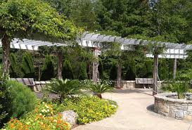Here, a crisp white arbor rises out of a boxwood hedge and is crowned dramatically with climbing roses. Garden Arbors And Arches Metal Stone Wood And Plastic Arbor Ideas