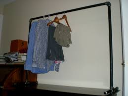 Old tubes and connections from a scaffold to make the wardrobe frame and repurposed planks as shelves for the clothes rack. Free Standing Clothing Rack Instructables