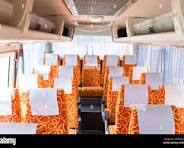 orange fabric vehicle seat in interior mini bus Stock Photo ...