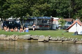 The campsite is mostly flat and level, mostly grass, some stony ground. Tcs Camping Gampelen Spottocamp