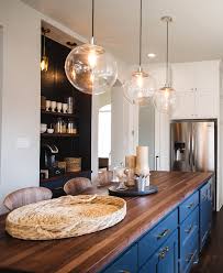 Blue vaulted kitchen ceiling in a contemporary kitchen designed with blue and white moroccan tiles, white cabinets and marble countertops. White Kitchen With Navy Blue Island Home Bunch Interior Design Ideas