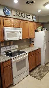 Adding Cottage Warmth To A Galley Kitchen Oak Cabinets Blanco Tulum Granite Gettysburg Grey Paint Sage Kitchen Soffit Kitchen Renovation Honey Oak Cabinets