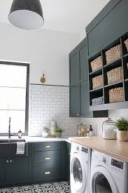 Laundry room with tile counters and sink. The Laundry Dog Room Dark Green Cabinets Layered On Classic Black White Design The House Of Silver Lining