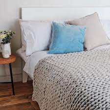 Add a touch of warmth to your bed with a craftily placed blanket or throw. This Primark Chunky Knit Throw Is A Hit On Instagram
