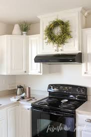 Christmas in the kitchen with mini wreaths on cabinet doors. Quick And Easy Greenery Wreath Farmhouse Made