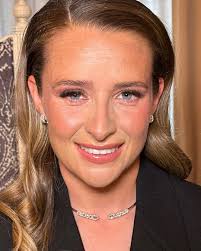 My daughter met her football idol Ella Toone, who kindly agreed to a photo.  Only problem it was in the toilets. Can anyone improve the background  please. Manchester United player in case