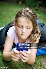 Texting On The Grass High-Res Stock Photo