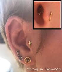 tragus piercing from yesterday wearing a solid yellow gold cross from anatometalinc done on a beaut tragus piercings tragus piercing jewelry body jewelry