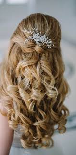 Sexy model with dark curly hair styled with a side parting and holding a camera in her hand looks sensuous. Fantastic 70 Wedding Hairstyles For Curly Hair Ideas Curly Wedding Hair Long Hair Styles Curly Hair Styles