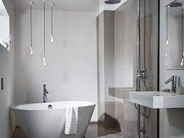 Modern bathroom featuring a tiny white tub and compact shower unit. Clever Small Bathroom Design Ideas To Save Space Grand Designs Magazine