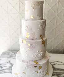 The gold geometric designs on this cake table are accented with gold foil encircling the cutting cake. Unique Wedding Cake Trends New Cake Designs 2019 2020