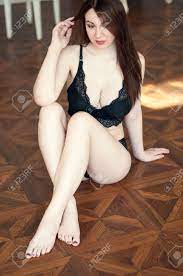 Brunette Cute Girl With Big Breast, She In Black Lingerie, Sitting On Wood  Floor Stock Photo, Picture and Royalty Free Image. Image 108296513.