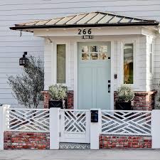 Black is a great front door color option for a gray or white house, or a home with red. White Beach House With Blue Door Design Ideas
