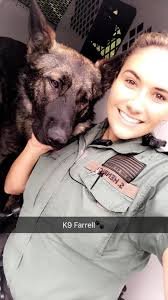 Dep. Shannon Henrici shows K9 Farrell some love. K9 Farrell was sleepy  after a long day.