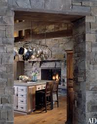 The highly trained professionals at consolidated kitchens and fireplaces will assist you through the process of choosing kitchen cabinets and designing your room, resulting in a space that you will love. Take A Peek Into Dennis Quaid S Wood And Stone Residence In Montana Rustic House Rustic Kitchen Design Kitchen Fireplace