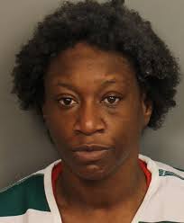 A woman has been charged with a deadly shooting Wednesday in Birmingham.  She was taken into custody at the Ensley Highlands house where five men  were murdered more than a decade ago.