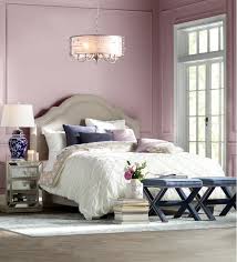 Look at how the clean lines of the white metal canopy bed pop against the purple paint, while the patterns on the artwork and the shams add just enough contrast to keep things hopping. 20 Amazing Purple Bedroom Decor Ideas