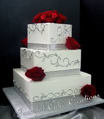Elegant Square White Butter Cream Wedding Cake Decorated With Silver Ribbon And Scrolls And Red Roses Cream Wedding Cakes Wedding Cake Red Wedding Cake Decorations