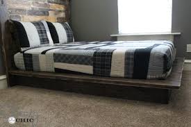 The bed is on a floating platform and the nightstands are incorporated into the frame for a really sleek, minimalist look. Easy Diy Platform Bed Shanty 2 Chic