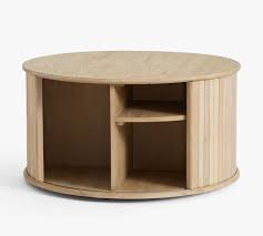 The storage compartments come in various styles: Arlo 31 Tambour Round Storage Coffee Table Pottery Barn