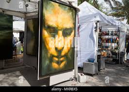 Spring Festival in Gainesville, Florida, features a variety of expression  and experiences. Man tries out a Wooden Electric Chair creation for sale  Stock Photo