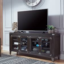 Discreet storage areas offer ample space for stowing media accessories and electronics. Todoe 70 Inch Xl Tv Stand Bernie Phyl S Furniture By Ashley Furniture