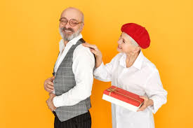 Picking out a gift for lovestruck newlyweds is hard enough, especially if they've been living together for a while already. Free Photo Charming Short Haired Middle Aged Woman In Red Bonnet Holding Box Of Chocolate Giving Birthday Present To Her Handsome Cheerful Husband