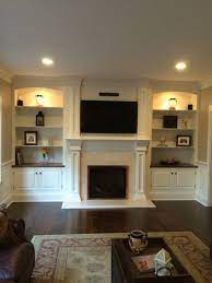 Built in shelving around fireplace and tv floating shelves. Awesome Built In Cabinets Around Fireplace Design Ideas Decomagz Built In Shelves Living Room Fireplace Built Ins Built In Cabinets Around Fireplace