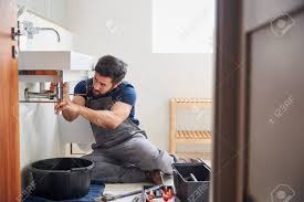 male plumber working to fix leaking