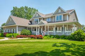 Wrap around porches utilize stylistic details in their construction to define a house's style. Wrap Around Porch Quality Hardscapes Porch Masters