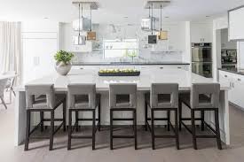 Reformcph.com has been visited by 10k+ users in the past month Five Gray Leather Cutout Barstools Sit At An Expansive Kitchen Island Topped With White Quartz I White Modern Kitchen Bar Stools Kitchen Island Grey Bar Stools