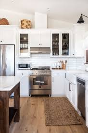 When planning a new kitchen or major remodel, a key decision you'll need to make is whether to run the upper wall cabinetry all the way to the ceiling or to install cabinets with a gap above them. Tall Ceiling Kitchen Cabinet Options Centsational Style
