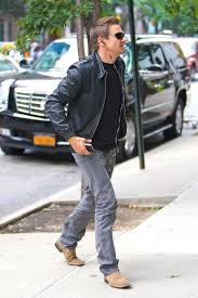 Jeremy Wearing Black T Shirt Blue Jeans Black Leather Jacket Brown Boots And Sunglasses While Listening To His Ipod Jeremy Renner Leather Jacket Jeremy