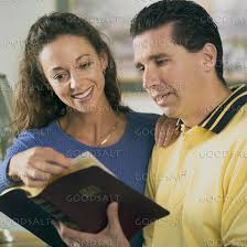 A husband and wife reading the Bible together.