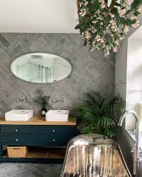 A minimalist bathroom done with wood look tiles and mosaic ones on the floor and bathtub wall for a pattern a minimalist bathroom fully clad with wood look tiles on the walls and floor plus a white floating vanity a minimalist bathroom with white large scale tiles and wood look tiles in the shower space and an accent by the toilet The Top 100 Bathroom Wall Tile Ideas Bathroom Design