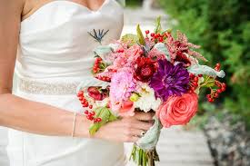 Combining calla lilies, roses, and small berries is a great way to maximize both color and texture in a pink bouquet. Red Purple And Pink Bridal Bouquet