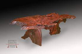 Table is made from a redwood tree trunk. Natural Edge Board Leg Coffee Table Jeffrey Greene