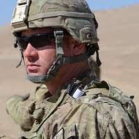 U.S. Air Force Col. Royce Lott salutes the colors during