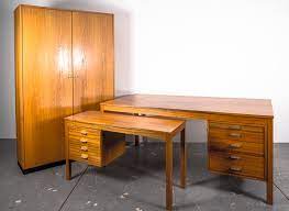 Made from a practical mixture of solid hardwoods and walnut veneers, this charismatic design features four long, tapered round legs and a classic silhouette. Mid Century Scandinavian Executive Desk Office Cabinet Set For Sale At Pamono